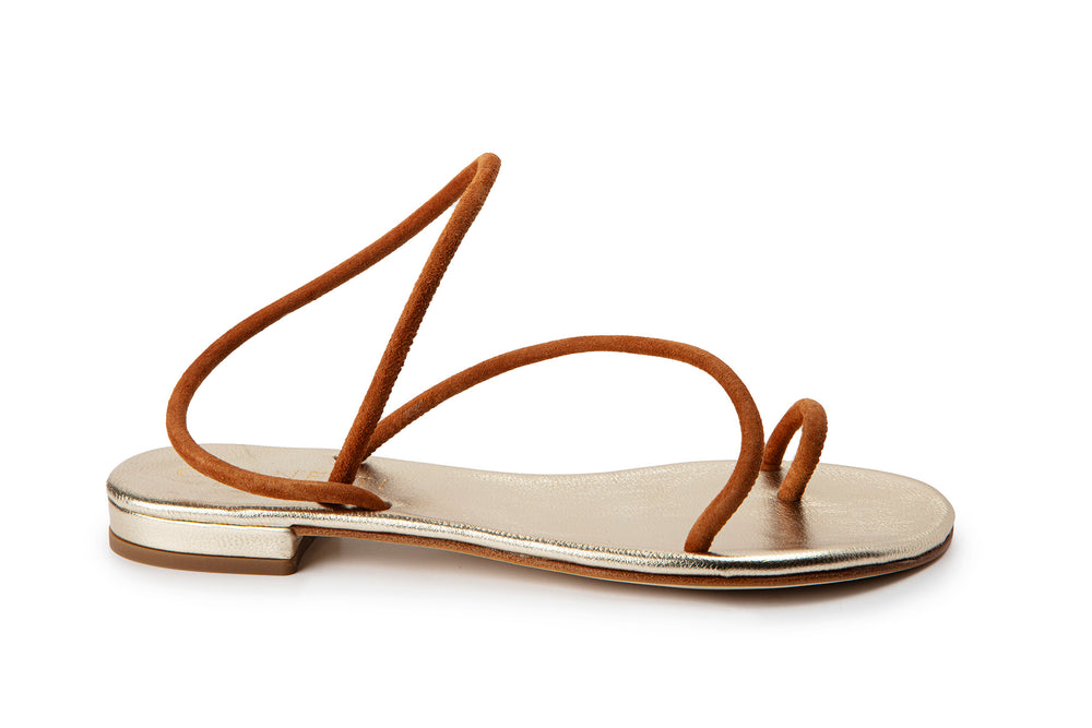 Side view of Romelide sandal in tobacco showcasing thin suede toe loop and arched ankle straps with metallic gold footbed on white background