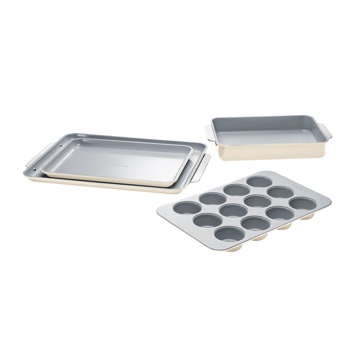 Angled view of half bakeware set with two sheet pans, one rectangular pan, and 12-cup muffin tin in cream and gray