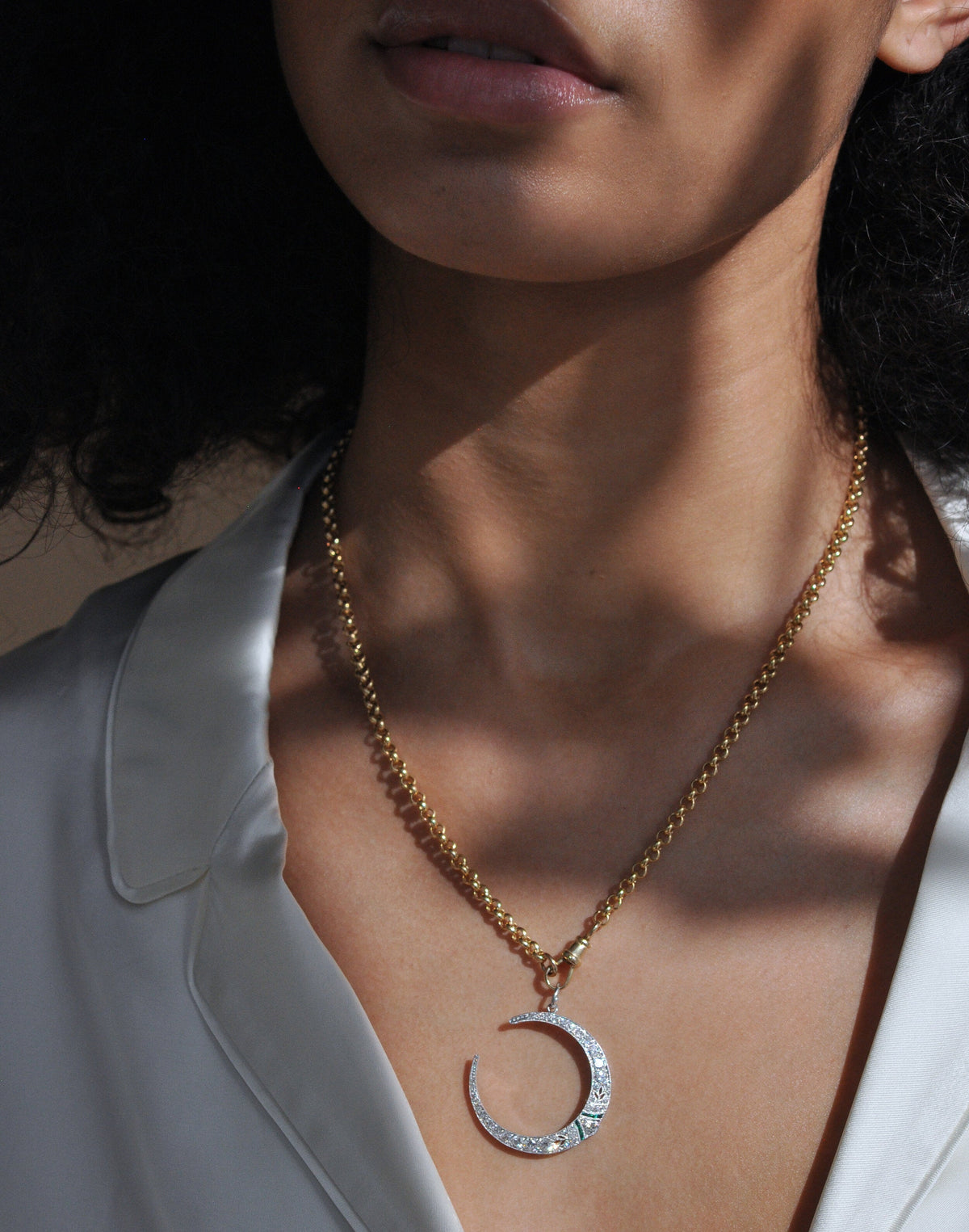 Close-up of model wearing 14K yellow gold Large Belcher chain with dog clip clasp showcasing chunky links and a pavé crescent pendant on a white blouse