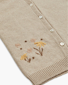 Beige cardigan with floral embroidery on a white background