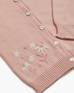 Pink knitted cardigan with floral embroidery on a white background