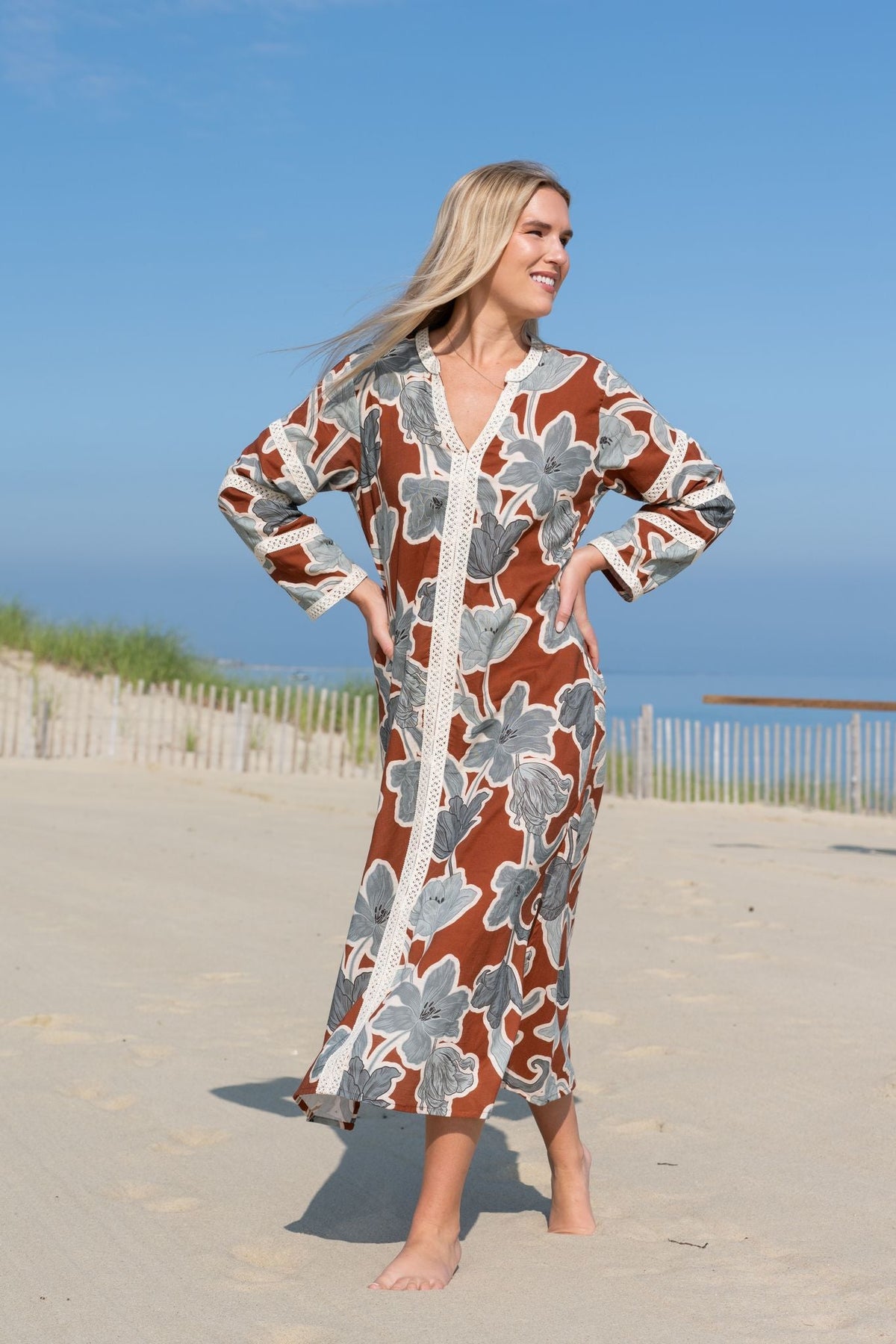 Front view of Bardot Merrain in Coco showcasing cotton lace trim and V-neck with a beach background