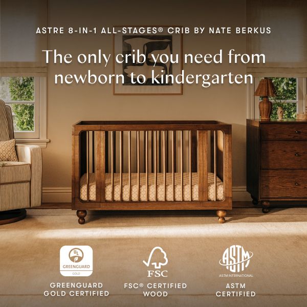 Front view of Astre All Stages 8 in 1 crib by Nate Berkus in Toffee showcasing newborn to kindergarten use in a nursery