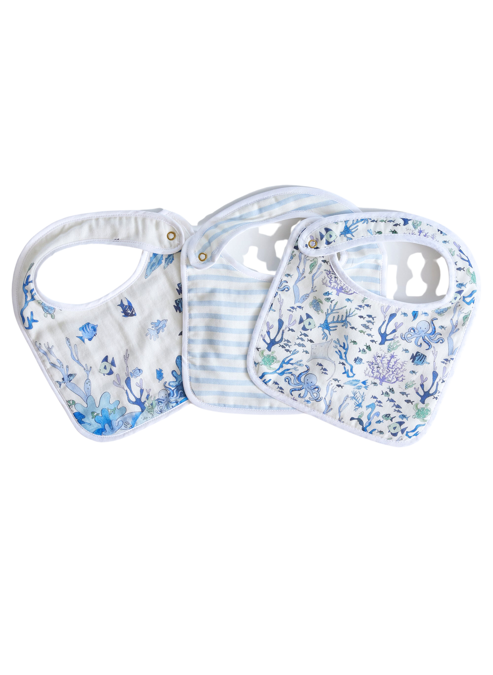 Flat lay of Under the Sea Bib Set showing three adjustable snap bibs with ocean-print muslin fronts and a blue-striped bib on white background