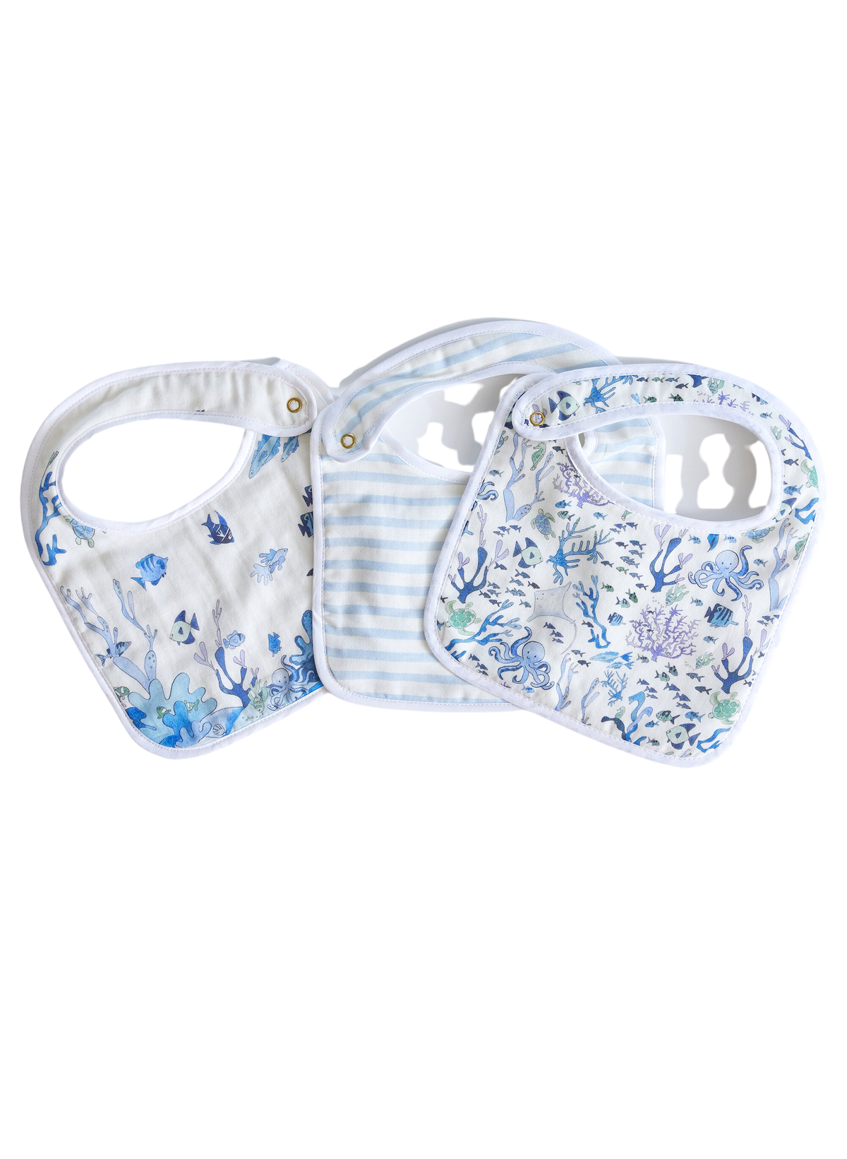 Flat lay of Under the Sea Bib Set showing three adjustable snap bibs with ocean-print muslin fronts and a blue-striped bib on white background