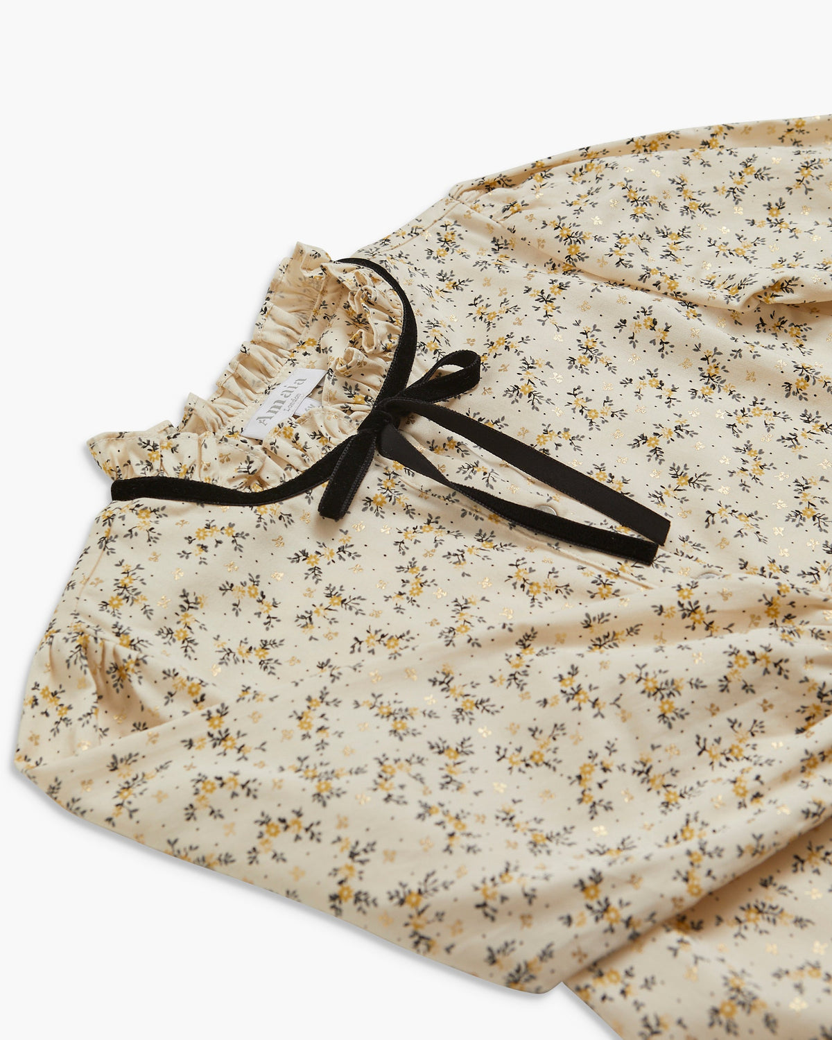Floral-patterned fabric with a black ribbon on a white background