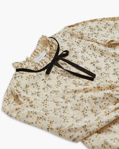Floral-patterned fabric with a black ribbon on a white background