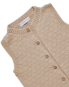 Beige knitted cardigan with button details on a white background