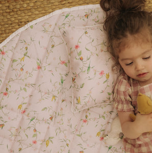 Dreaming of Paradise Playmat with little girl laying on top playing