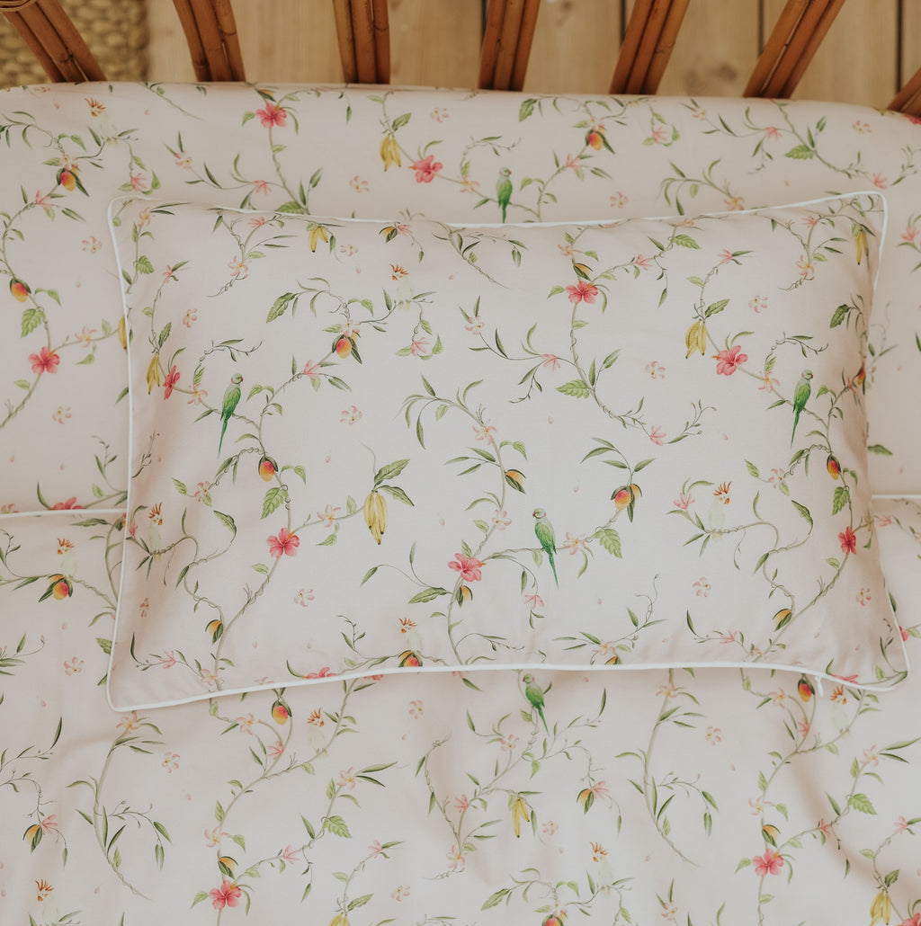 Dreaming of Paradise Toddler Pillow laying flat on top of crib sheet in Toddler bed