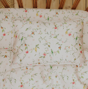 Dreaming of Paradise Toddler Pillow laying flat on top of crib sheet in Toddler bed