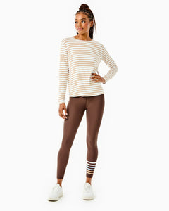 Model is wearing the Everyday Long Sleeve in Latte Stripe with the Everyday Legging in Chocolate