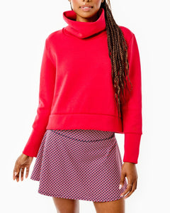 Model is wearing the Everyother Day Pullover in Cherry with the Flounce Skort in Navy/ Cherry stars