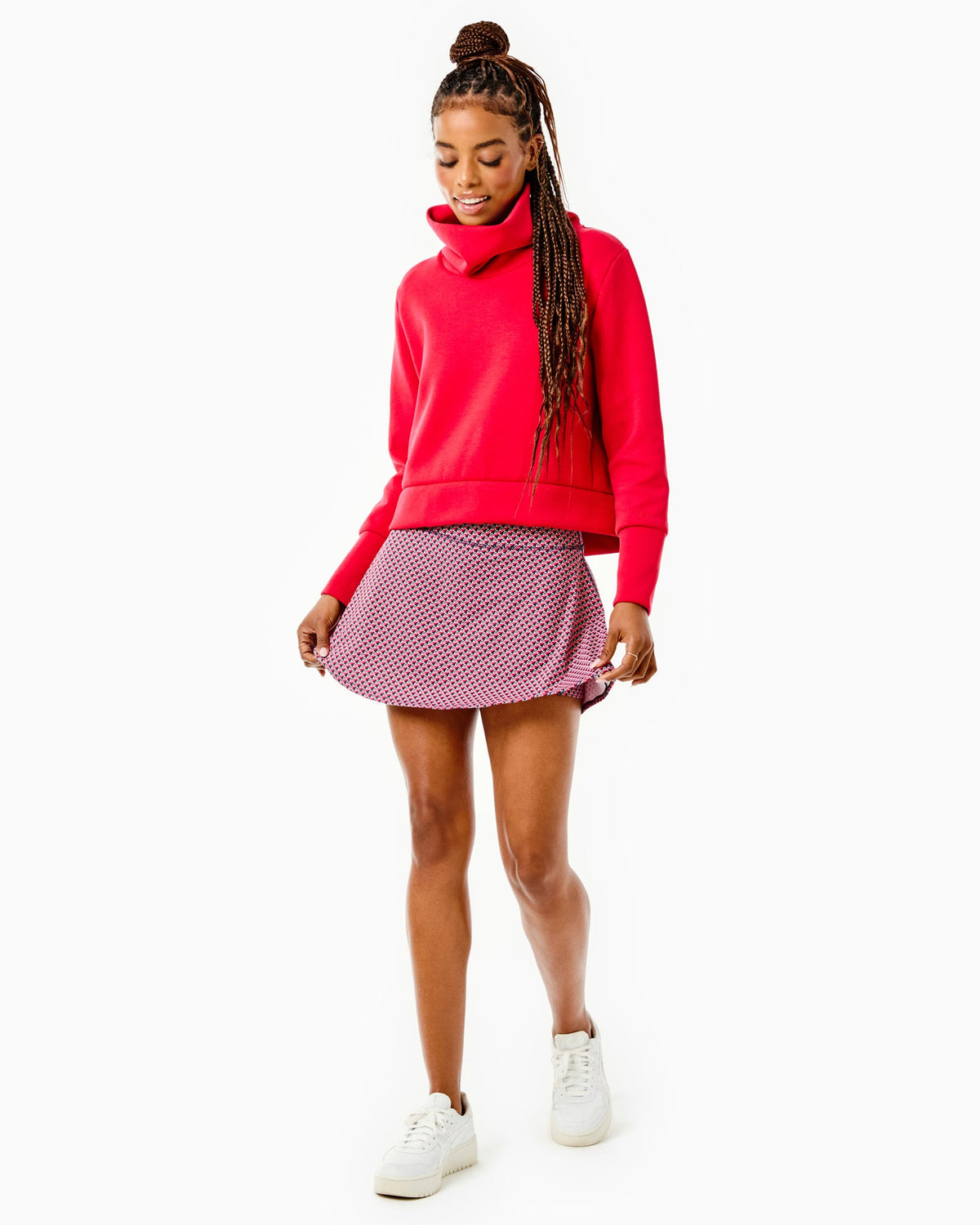 Model is wearing the Everyother Day Pullover in Cherry with the Flounce Skort in Navy/ Cherry stars