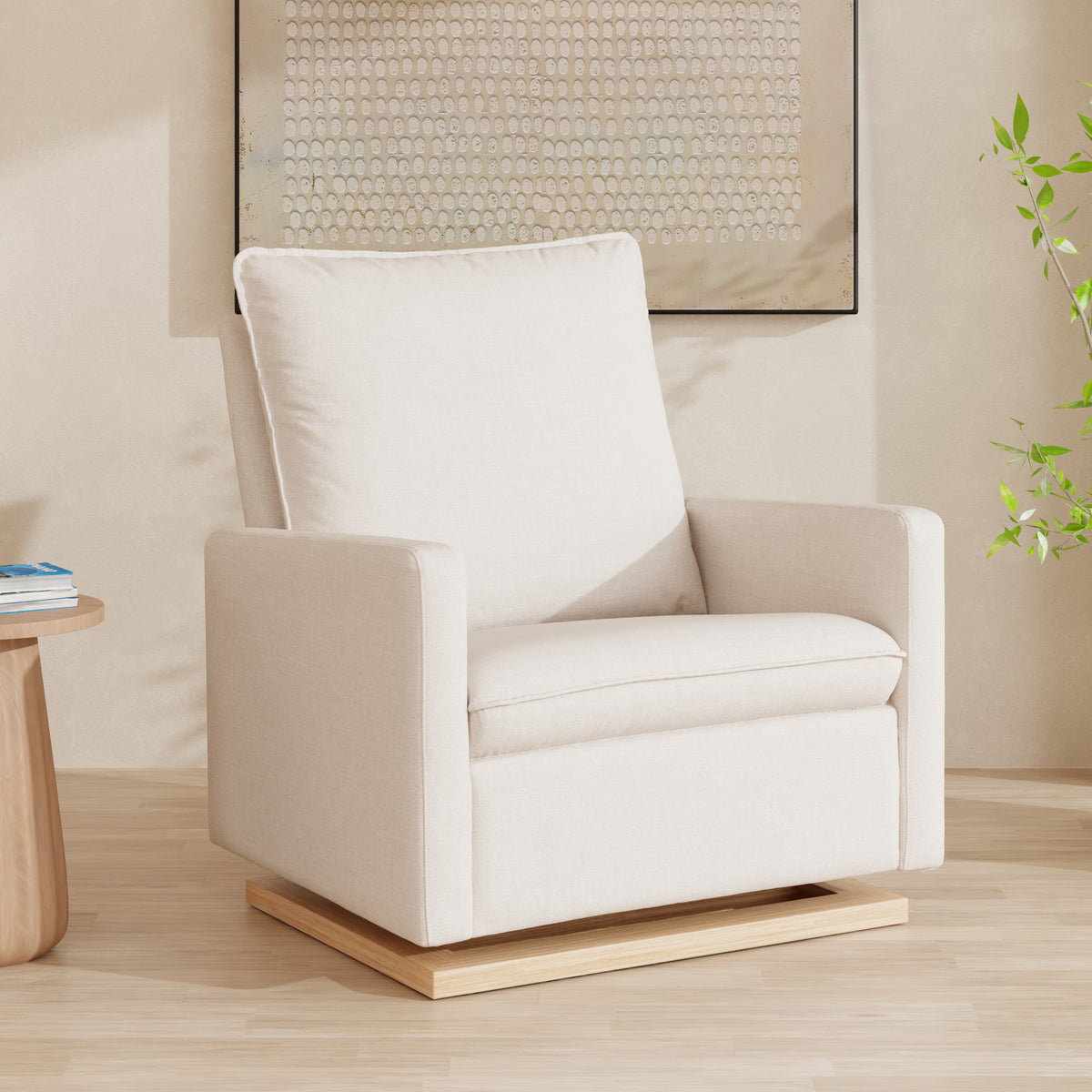 Three-quarter view of Cali Pillowback Chair and a Half Glider in cream Eco-Weave with light wood base in a neutral room