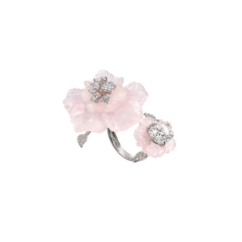 Angled view of Rose Quartz Sakura ring with carved rose quartz flowers and diamond centers on white background