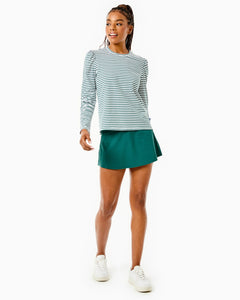 Model is Fairmount Long Sleeve in Super White/ Ivy Stripe with the Flounce Skort in Ivy