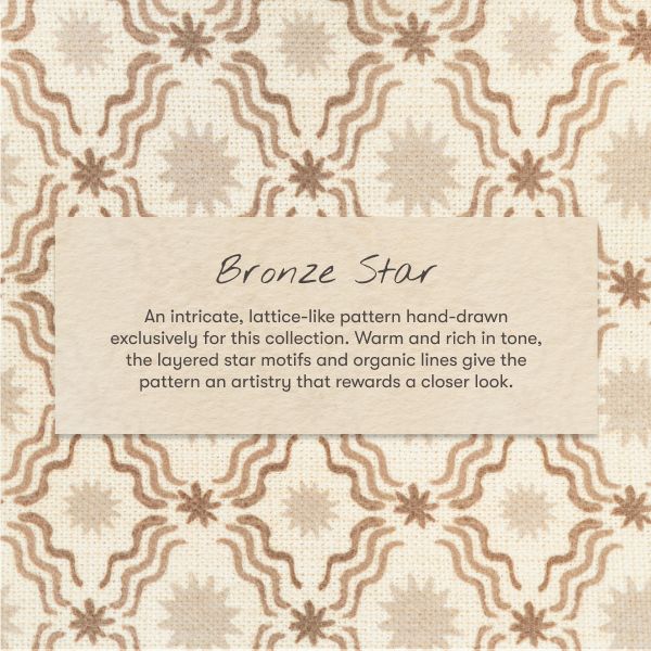 Close-up of All-Stages Midi Crib Sheet in Autumn Star showcasing layered cream and brown star motifs with Bronze Star pattern card