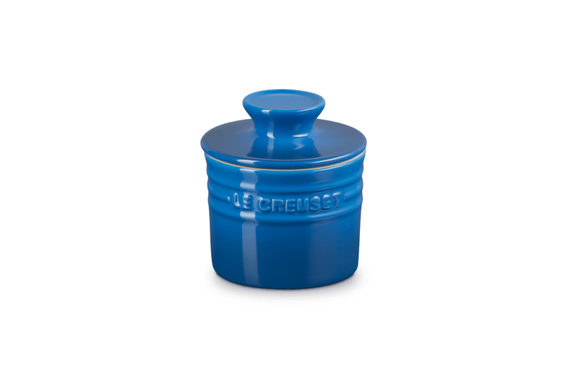 Front view of 6 oz Le Creuset Butter Crock in Marseille showcasing glossy blue stoneware and tight lid on white background