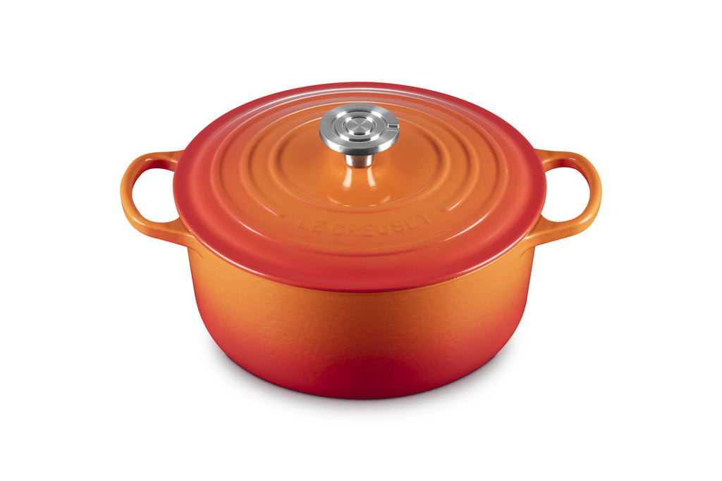 Front view of Signature Round Dutch Oven in Flame with stainless steel knob