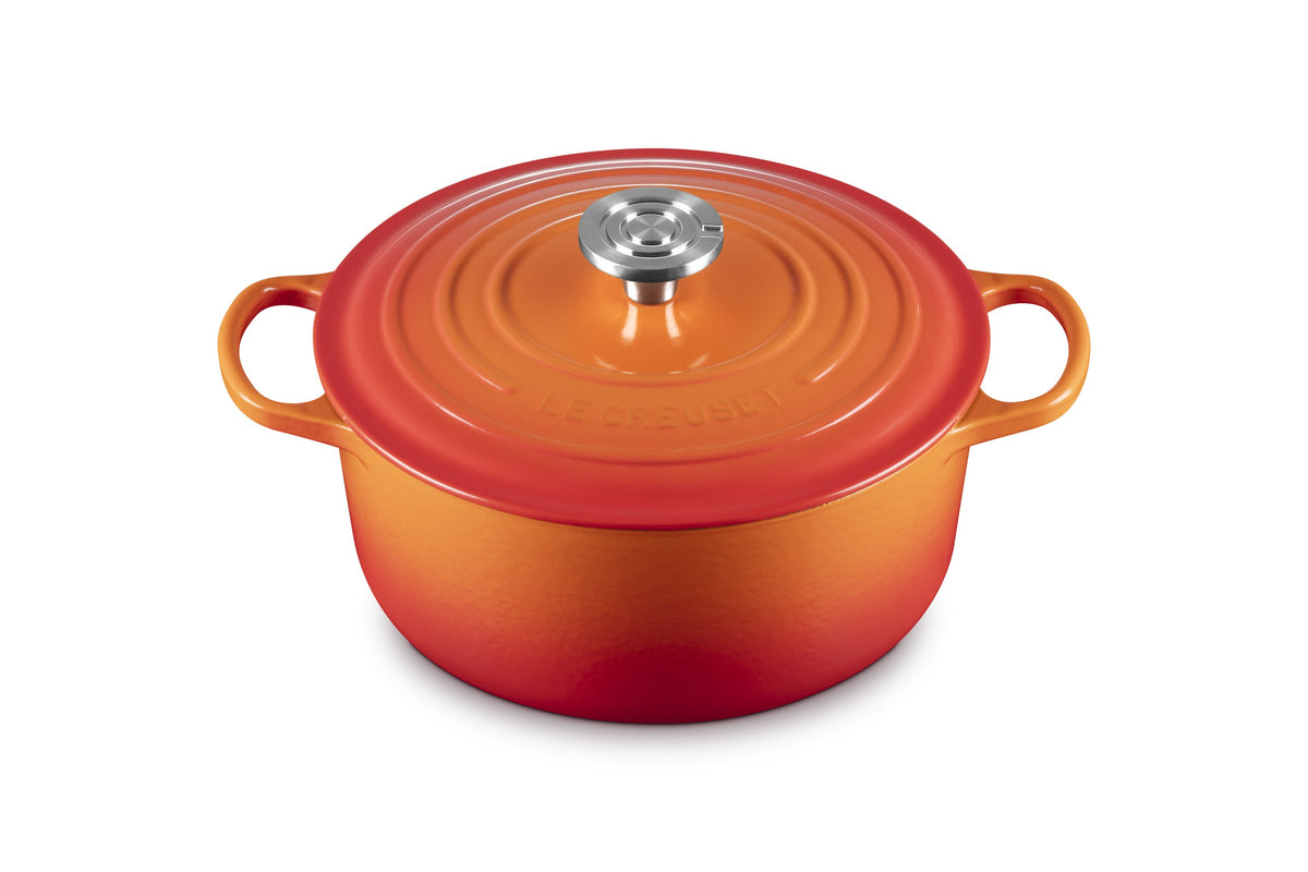 Front view of Signature Round Dutch Oven in Flame with stainless steel knob
