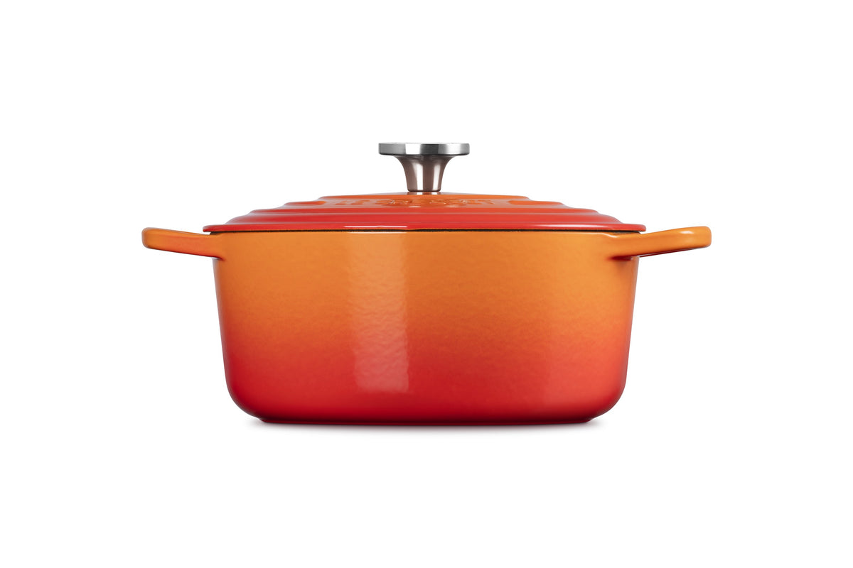 Side view of Signature Round Dutch Oven in Flame with stainless steel knob