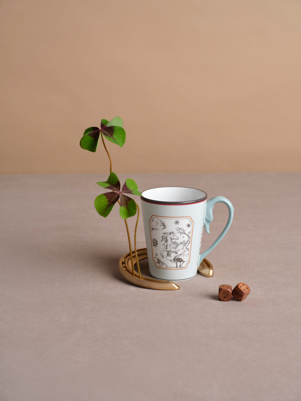 Fortunae Mug in Light Blue styled with a four-leaf clover and gold horseshoe