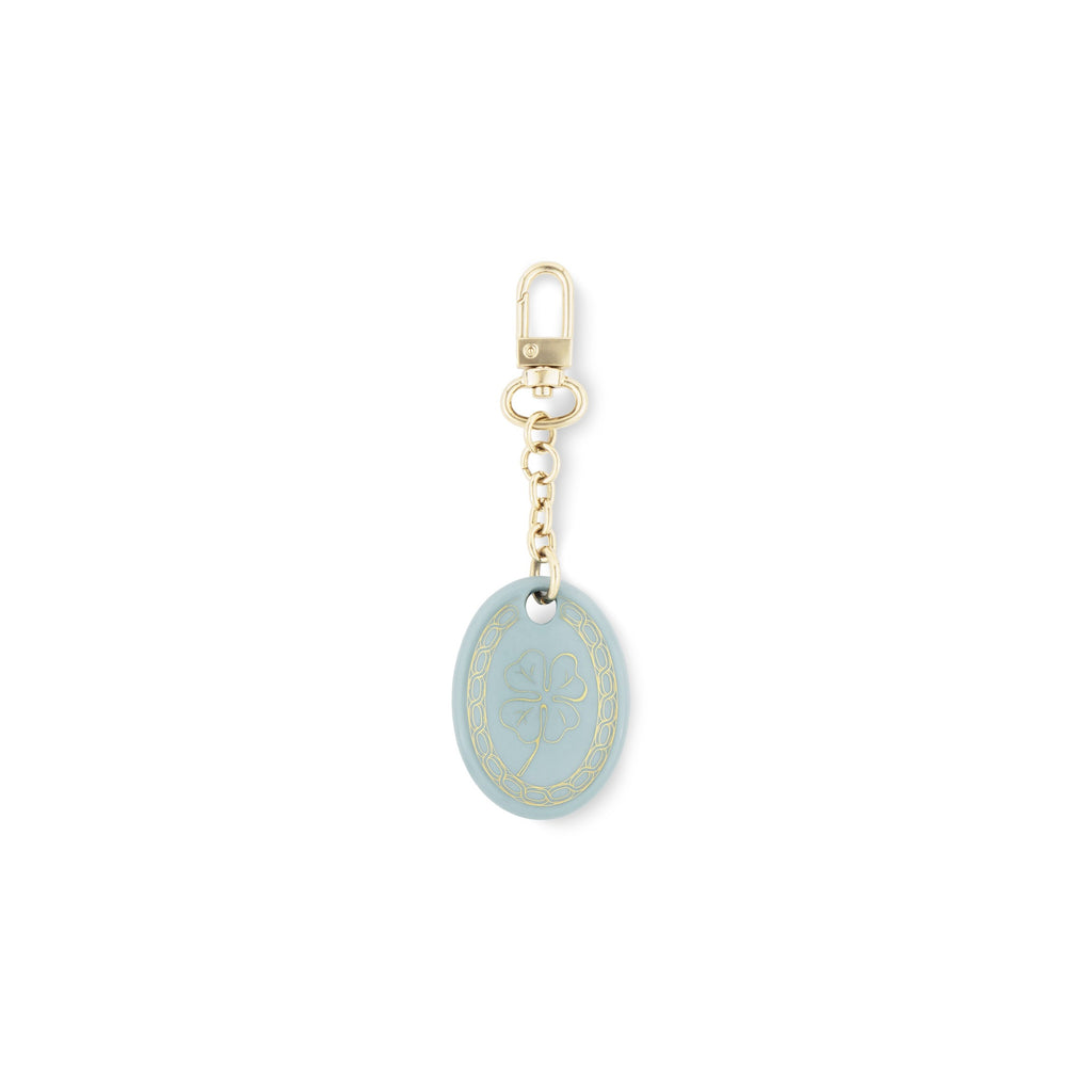 Fortunae Oval Charm in light blue porcelain with gold detail on a gold key ring
