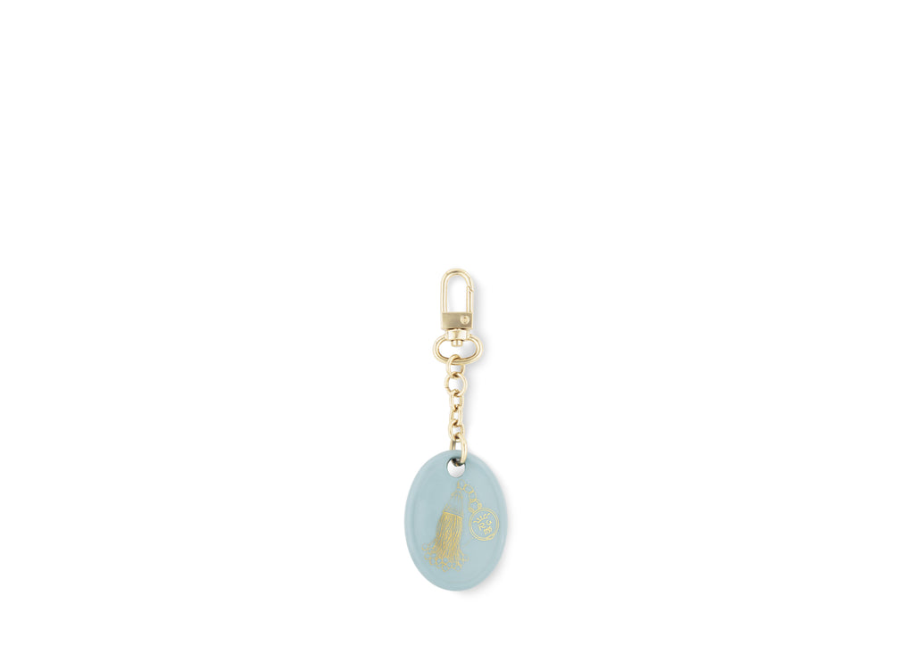 Fortunae Oval Charm, alternate pattern, in light blue porcelain on a gold key ring