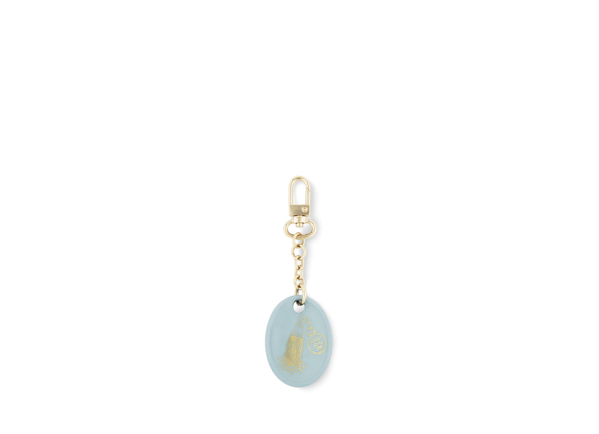 Fortunae Oval Charm, alternate pattern, in light blue porcelain on a gold key ring