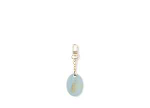 Fortunae Oval Charm, alternate pattern, in light blue porcelain on a gold key ring