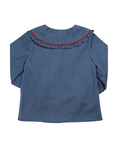 Blue denim blouse with red trim on a white background