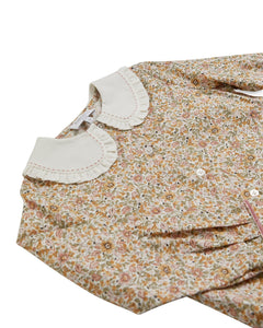 Floral dress with a white collar on a white background