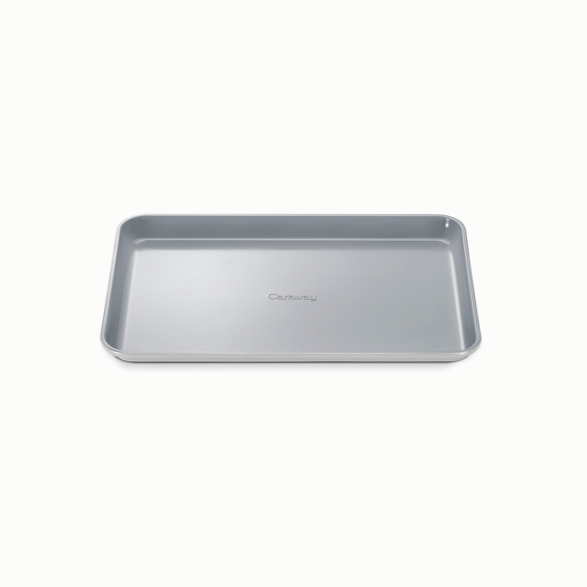 Angled top view of medium baking sheet with gray ceramic nonstick surface, reinforced rim, and Caraway logo on white background