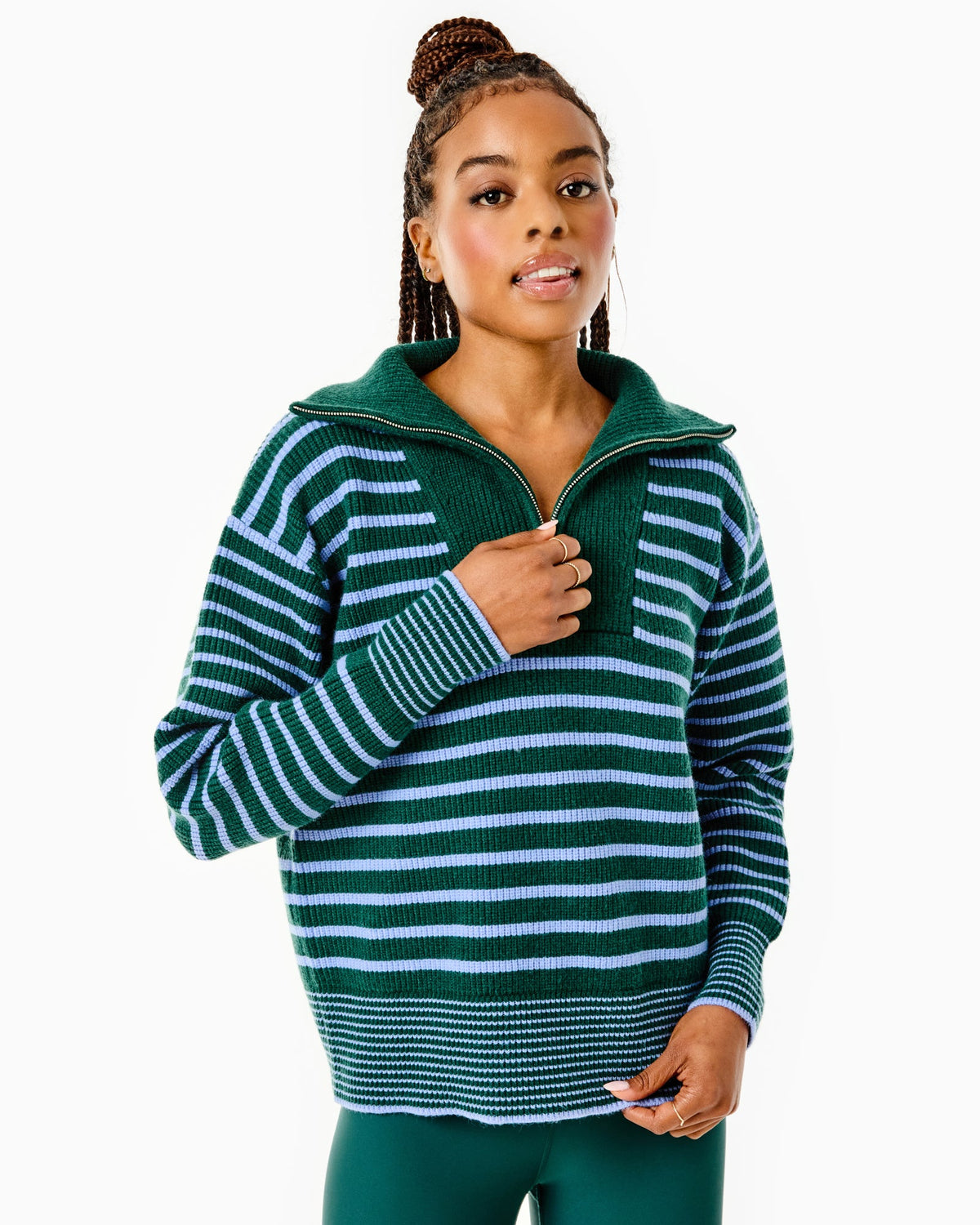 Model is wearing the Griffin Quarter Zip in Ivy/ Violet Stripe with the Everyday Legging in Ivy with violet stripes.