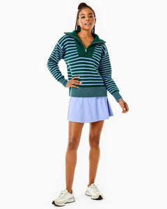 Model is wearing the Griffin Quarter Zip in Ivy/ Violet Stripe with the Flounce Skort in Violet