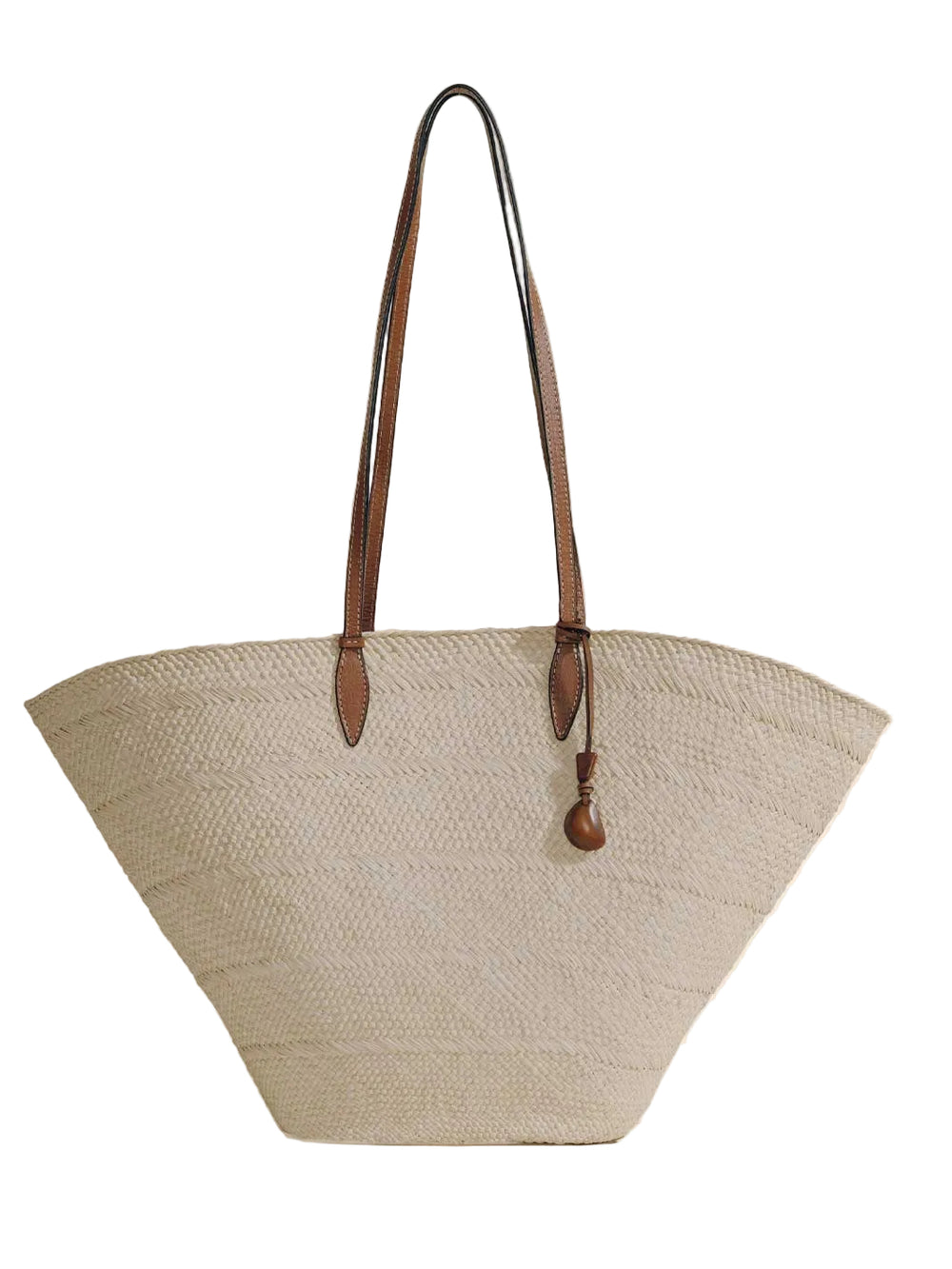 Front view of Large Trapeze Basket in natural cognac with handwoven iraca body, nappa leather straps and tagua charm on white
