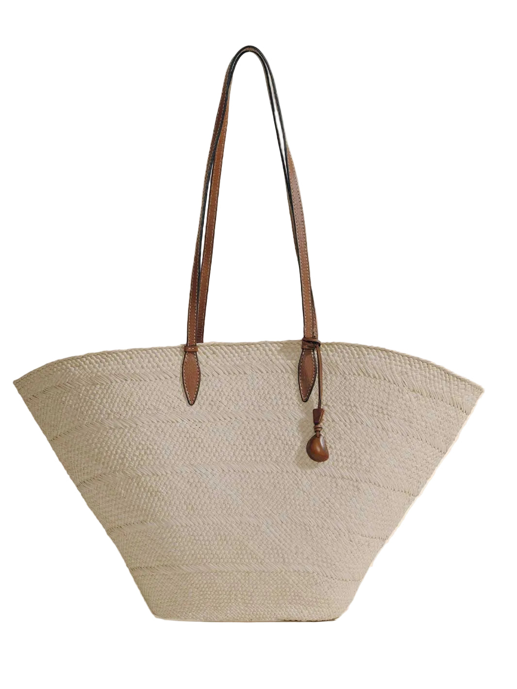 Front view of Large Trapeze Basket in natural cognac with handwoven iraca body, nappa leather straps and tagua charm on white
