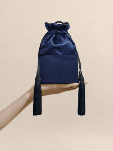 Front view of The Lola in Satin in Navy showcasing tassel detailing and structured base with a neutral background