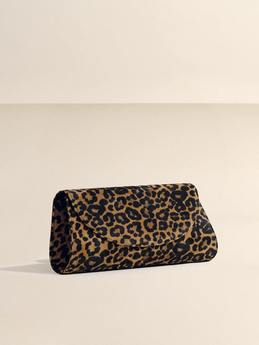 Angled front view of The Opera Clutch in Leopard Suede showcasing leopard pattern on a neutral background