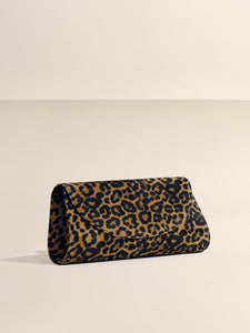 Angled front view of The Opera Clutch in Leopard Suede showcasing leopard pattern on a neutral background