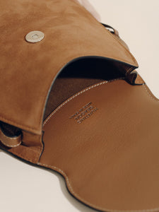 Close-up of The Small Western Trim Saddle in Cognac Suede showcasing smooth leather contrast trim and stitched detailing on a neutral background