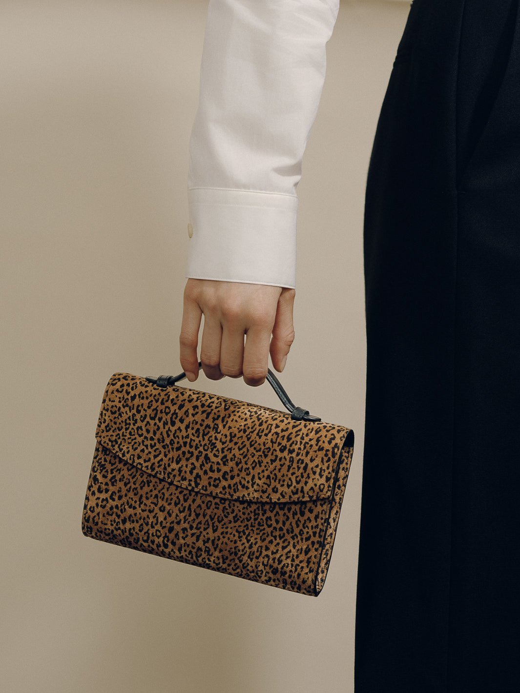 The Top Handle Clutch in Animal Print Suede