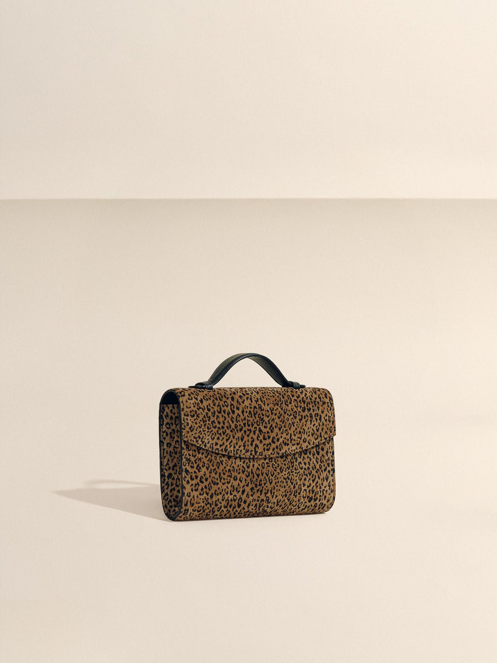 The Top Handle Clutch in Animal Print Suede