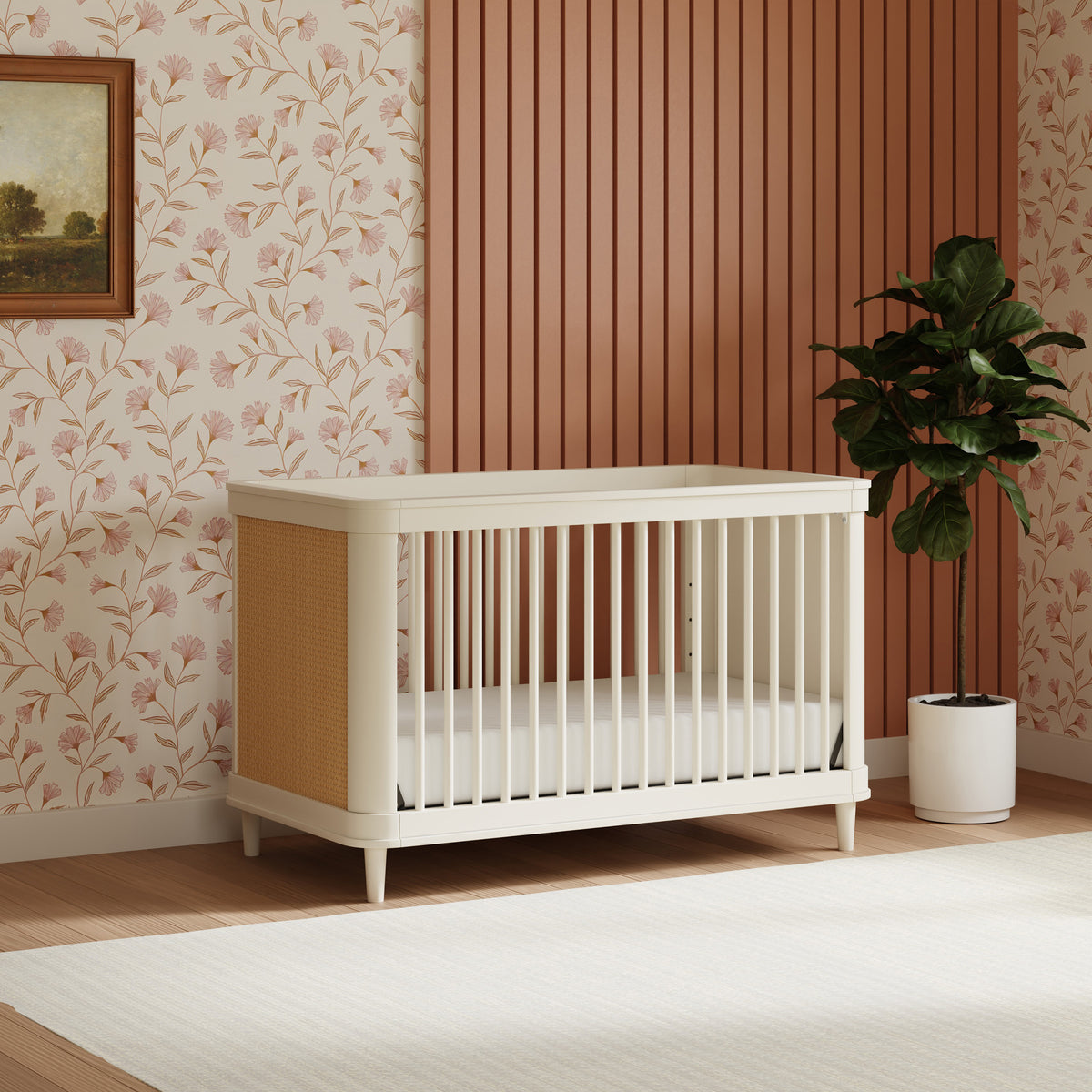 Three-quarter view of Marin with Cane 3-in-1 Convertible Crib showcasing honey cane side panels in a floral nursery
