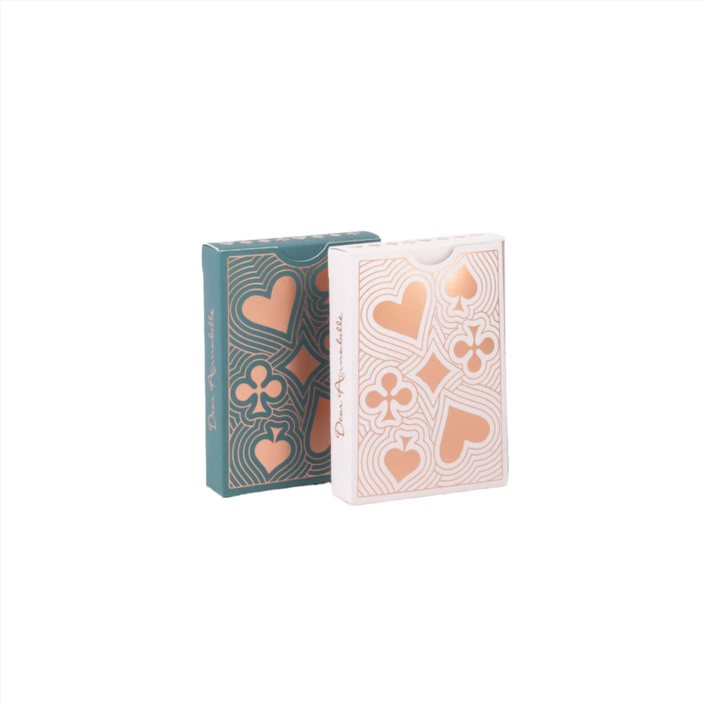 Two Lady Luck playing card decks, front view, showing rose-gold foil suits and soft-touch tuck boxes on white background