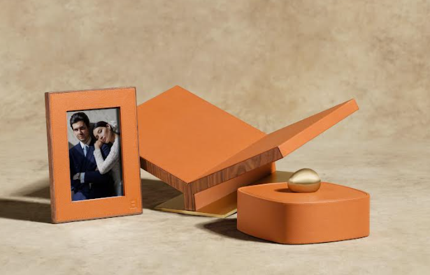 Front view of Heritage Frame in camel showcasing pebbled leather exterior and walnut edge with 5x7 photo on beige backdrop