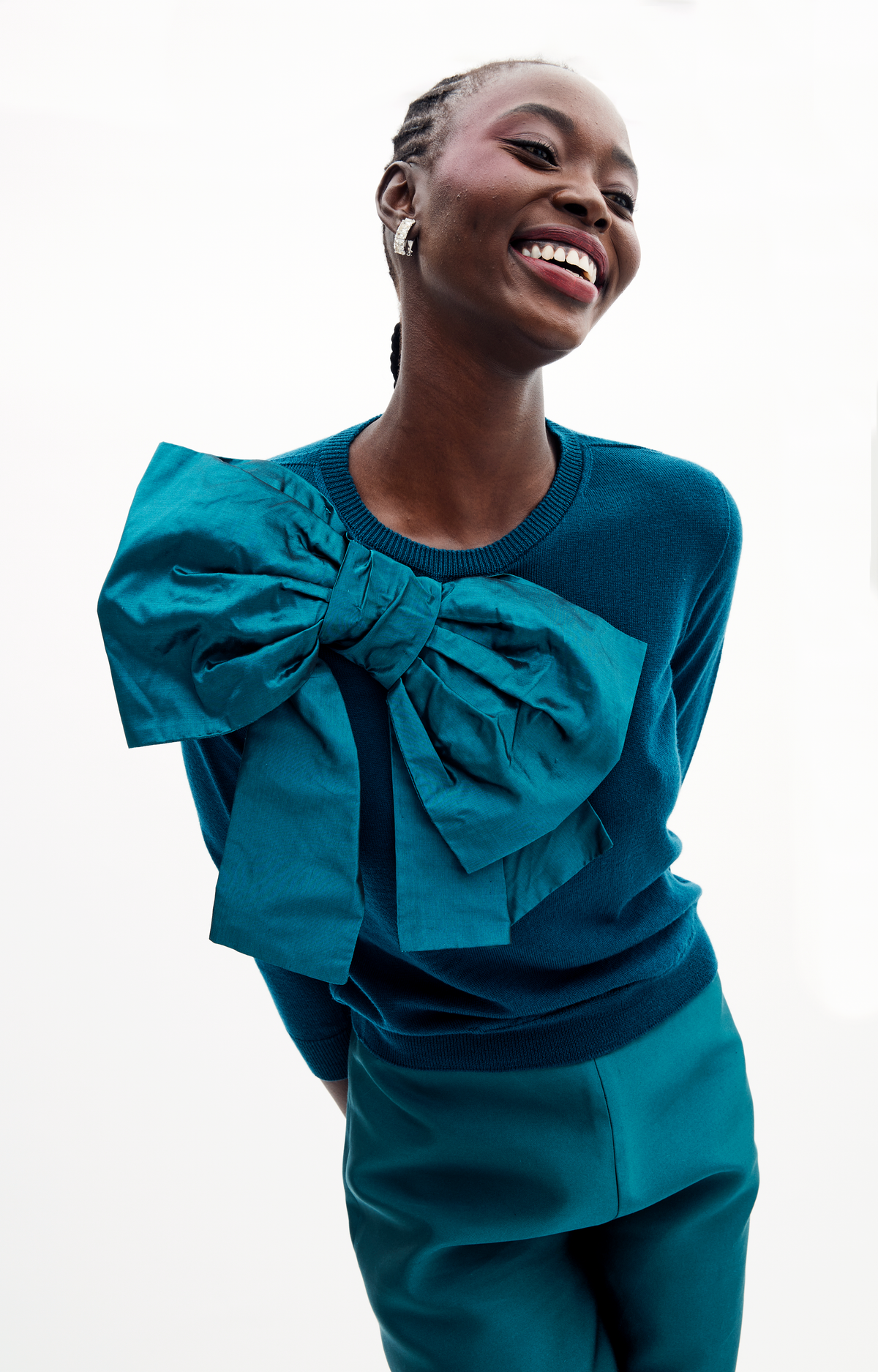 Front view of Patricia Sweater in Peacock showcasing its large bow detail on a model against a white background