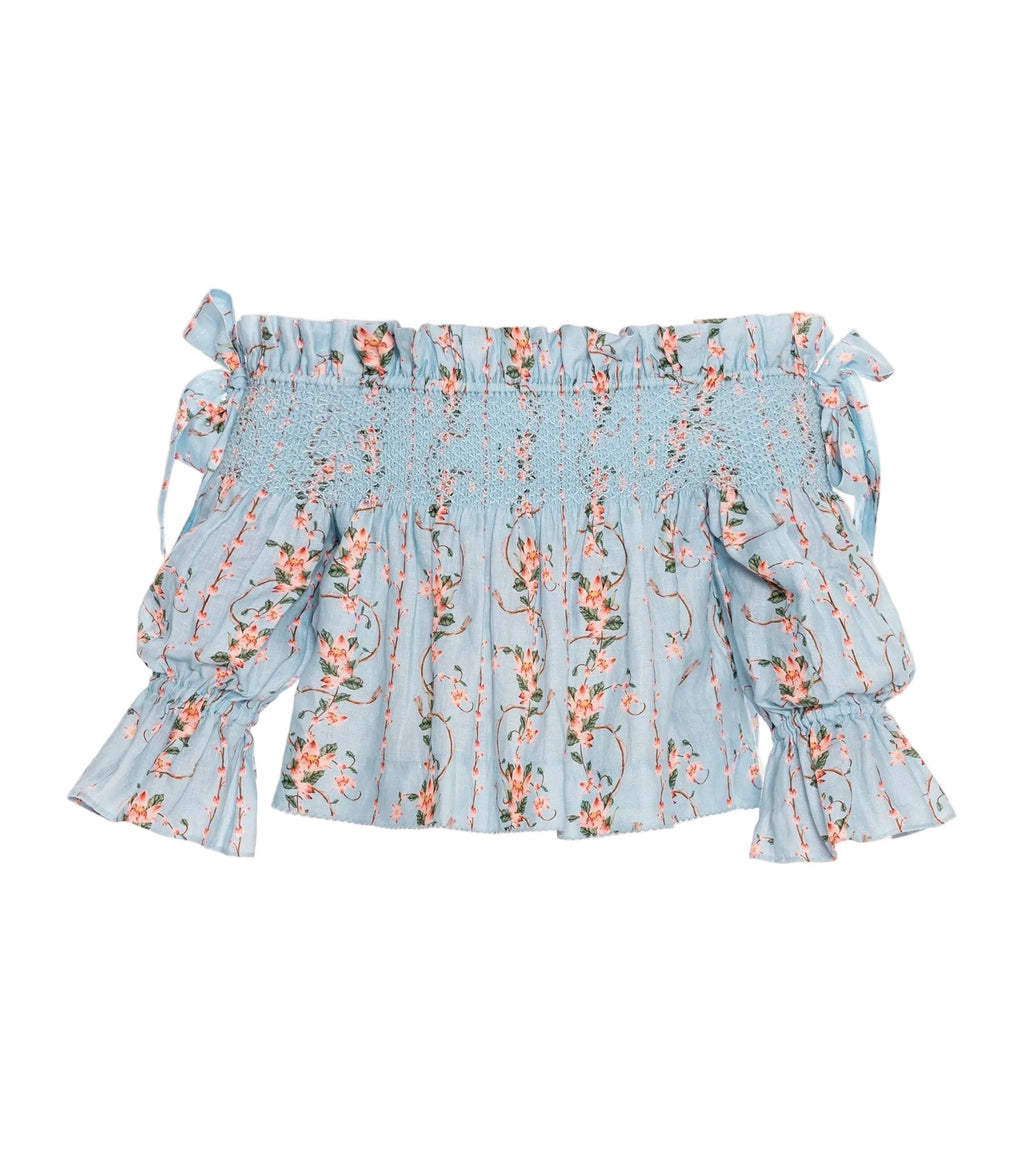 Front view of Isla Navegante Blouse showcasing off-shoulder neckline, smocked bodice, and floral print on white background