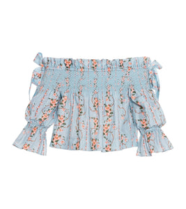 Front view of Isla Navegante Blouse showcasing off-shoulder neckline, smocked bodice, and floral print on white background